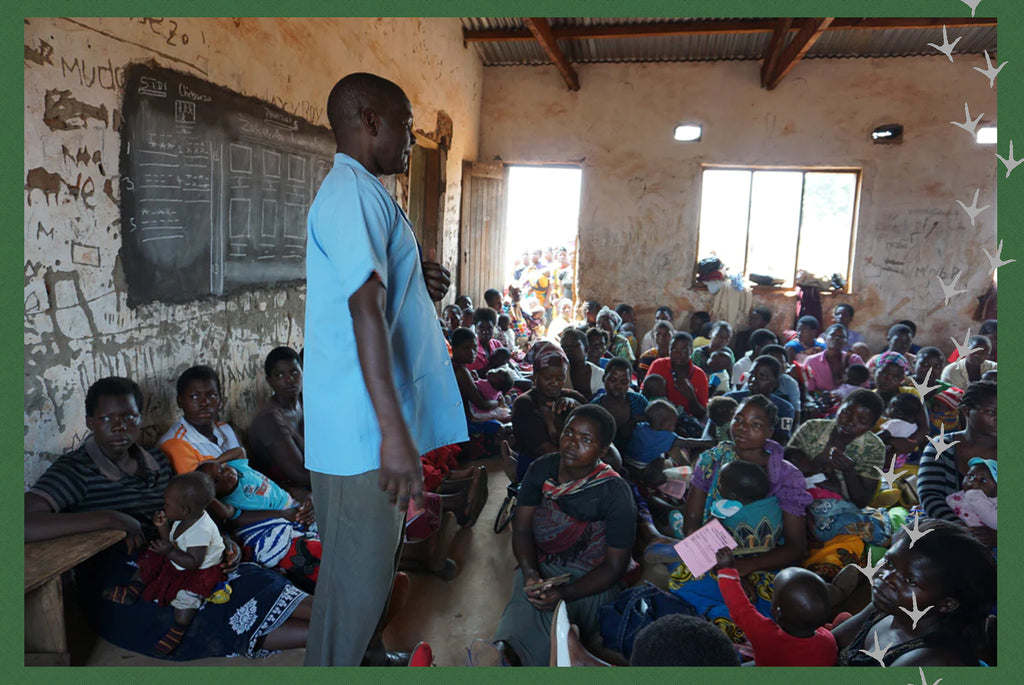 Man speaking to group of Malawian people